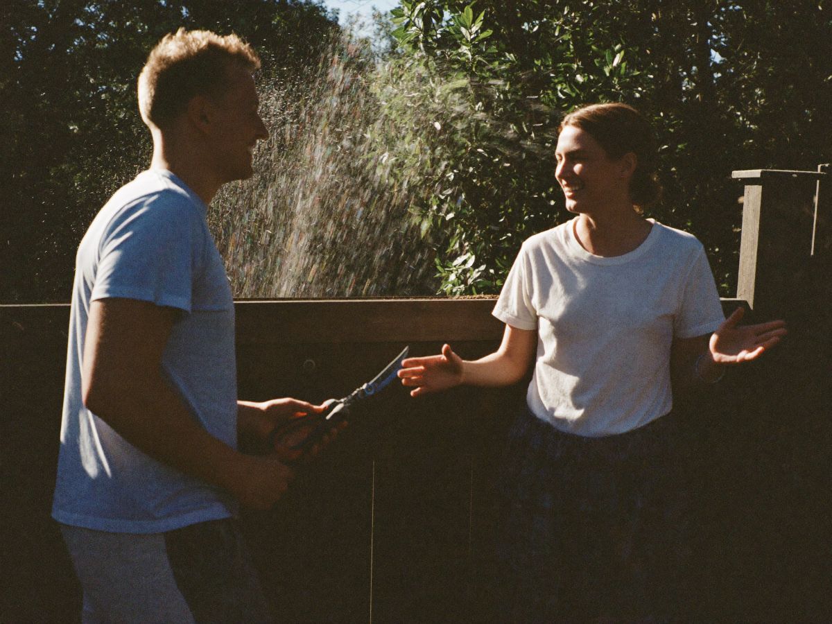 Neighbors talking over a fence